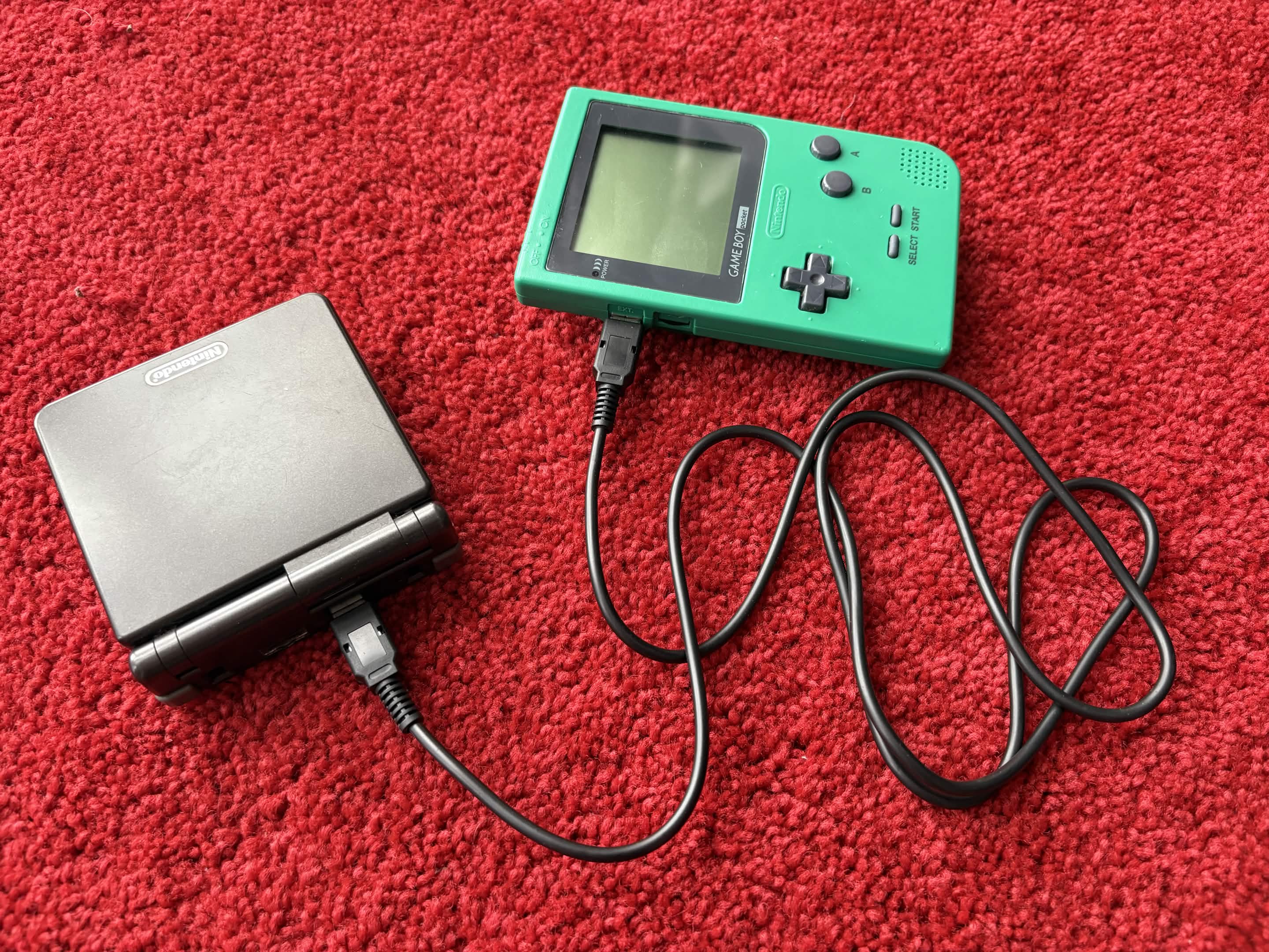 A photo of two Game Boys connected by a link cable