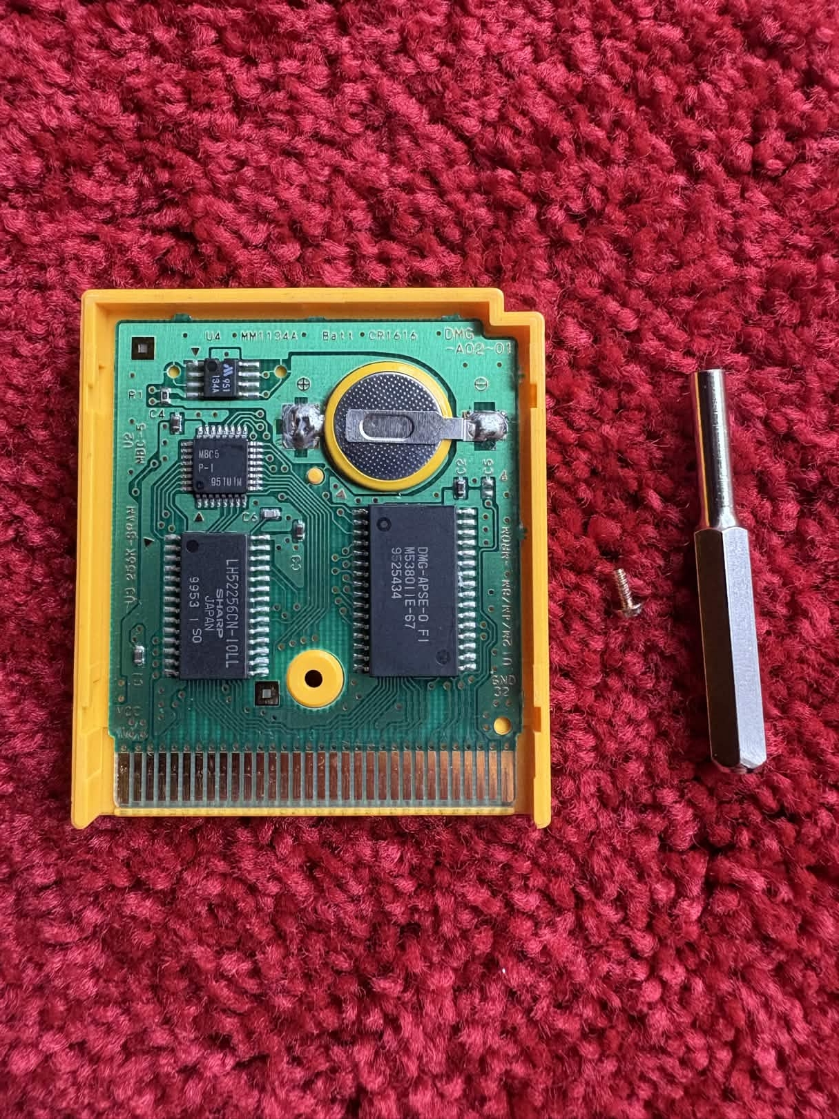 An open Pokémon cartridge showing the circuit board